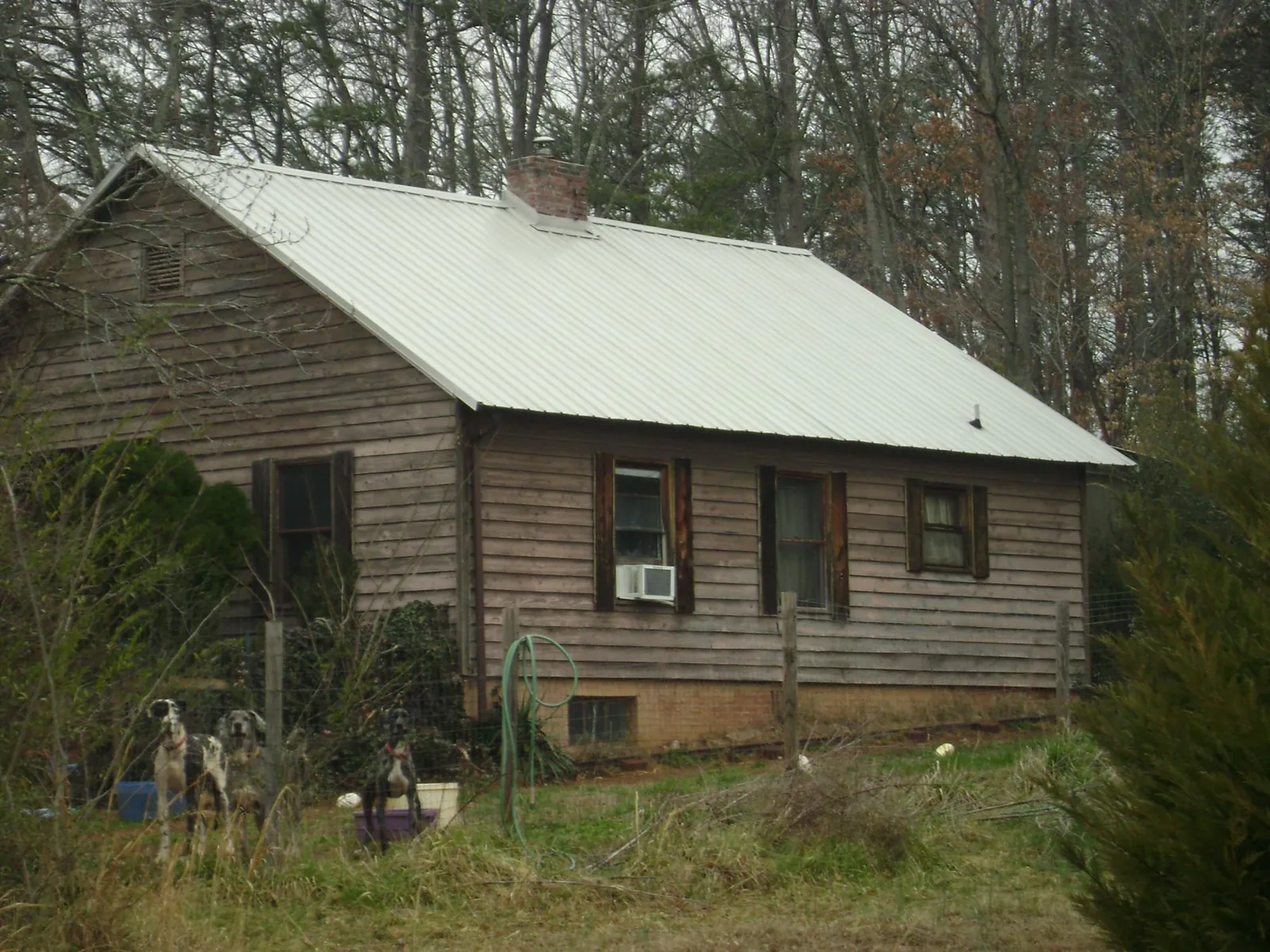 White metal roof on an old wood sided farmhouse, from a Metal Roof Installation job in Oliver Springs